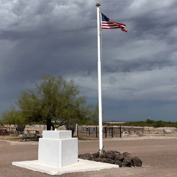 Florence Memorial Park Cemetery with American flag in the middle with gravestones behind it.