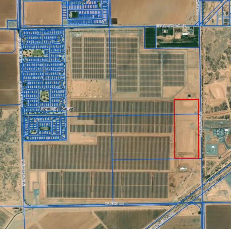 Aerial view of the Copper Crossing site west of Attaway Road with the long-duration energy storage pilot parcel outlined in red beside large existing solar arrays and a residential subdivision to the west