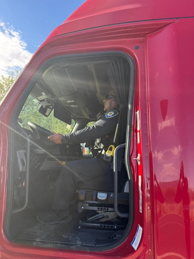 Officer sitting inside seized truck