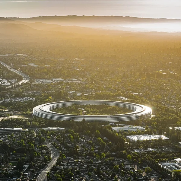 Aerial view of Apple Park's circular headquarters, nicknamed 'the spaceship,' at sunset in Cupertino, California.