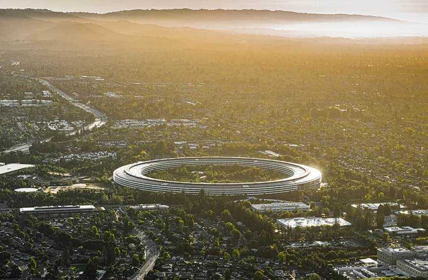 Aerial view of Apple Park's circular headquarters, nicknamed 'the spaceship,' at sunset in Cupertino, California.