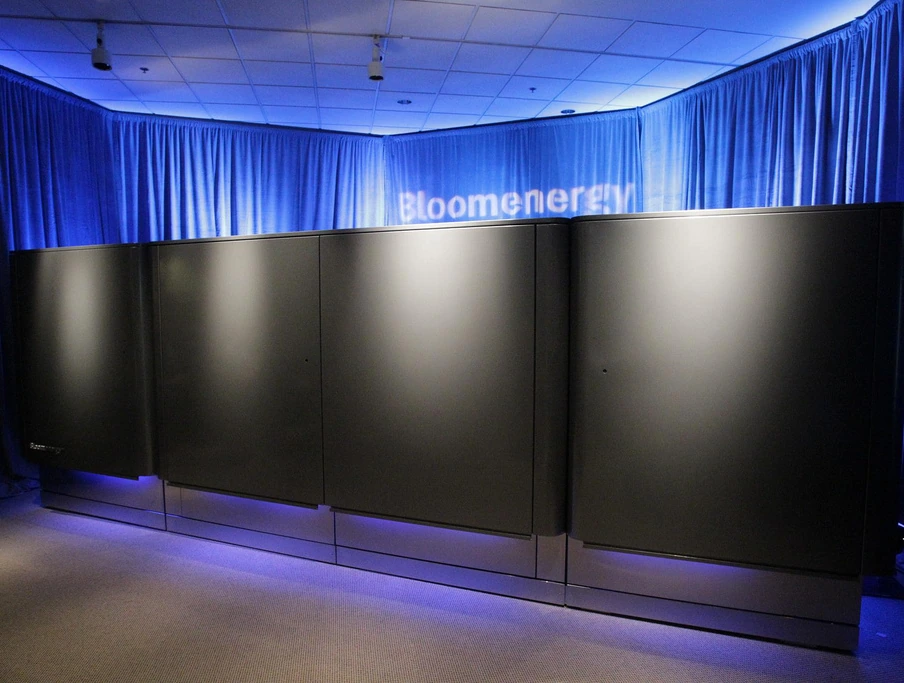 Black Bloom Energy Server cabinets displayed under blue lighting at the company’s 2010 launch.