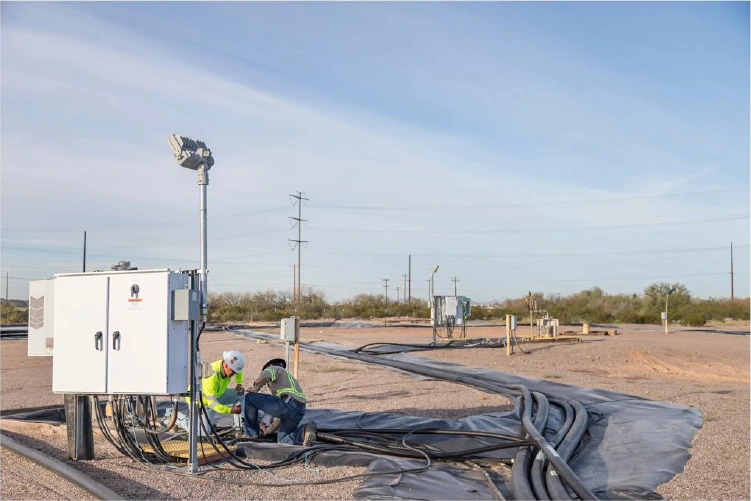 Workers among wellheads at the Florence Copper wellfield