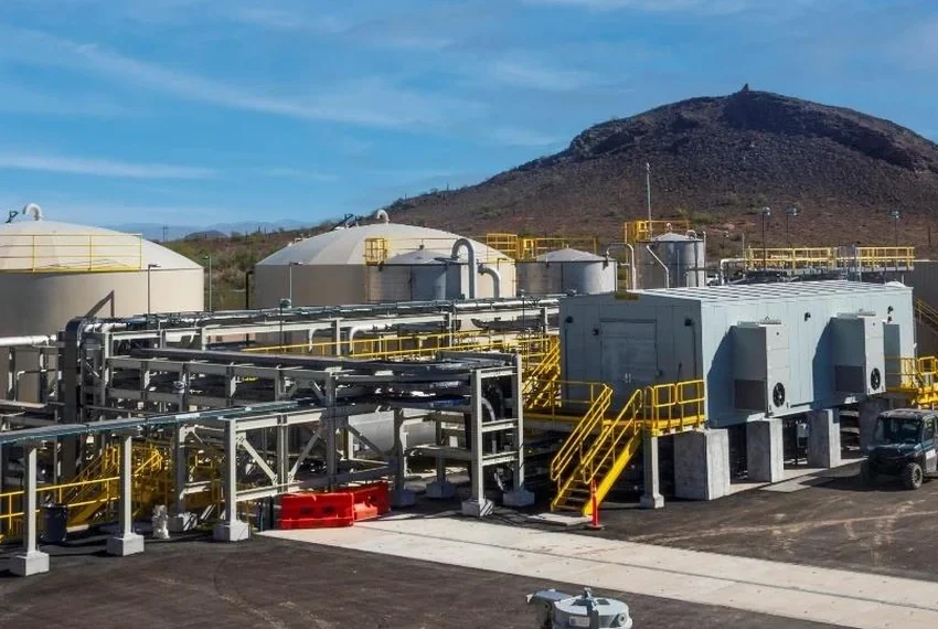 Storage tanks, piping and processing buildings at the Florence Copper facility, with Poston Butte rising in the background.