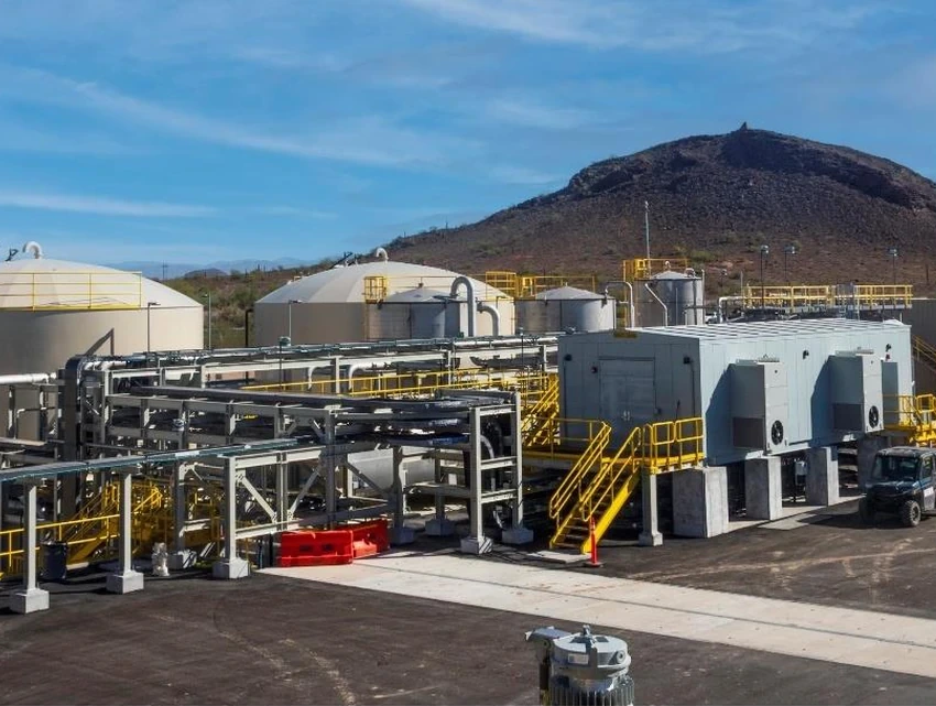 Storage tanks, piping and processing buildings at the Florence Copper facility, with Poston Butte rising in the background.