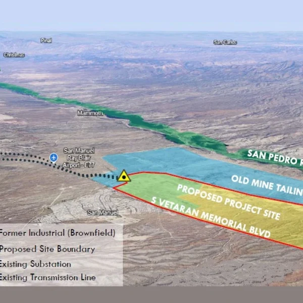Aerial rendering of the Ore Town Solar site beside San Manuel, Arizona. A red outline along Veterans Memorial Boulevard marks the proposed project site on part of a larger blue-shaded former industrial brownfield that includes the old mine tailings between the site and the San Pedro River. A marker at the site's corner shows the existing substation, with an existing transmission line running west past the town and airport.